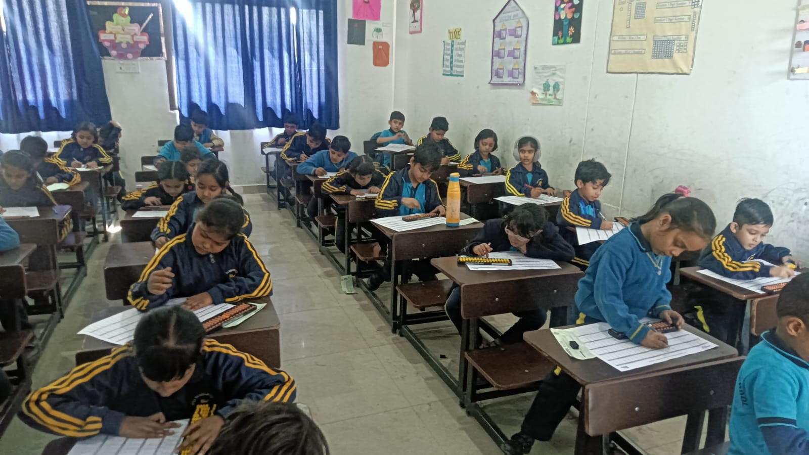 Students learning in a classroom at The Aryan International School